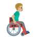 man in manual wheelchair facing right, medium-light skin tone